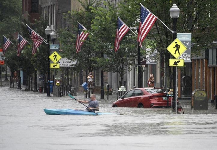 Flooded New England communities shift to recovery, shoveling out tons of mud and debris