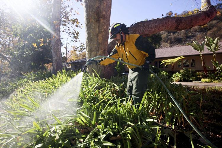 New wildfire warnings issued and more power is shut off as winds rise in Southern California