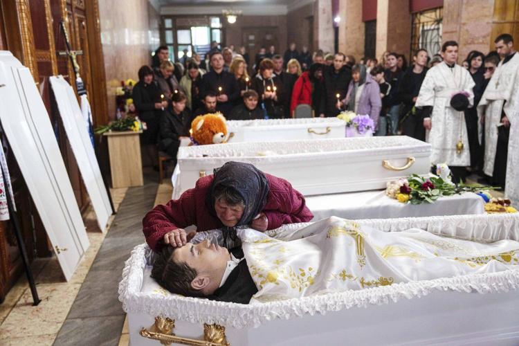 AP PHOTOS: 3 Ukrainian siblings buried after Russian missile strike