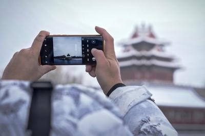 Snow blankets northern China, closing roads and schools and suspending train service