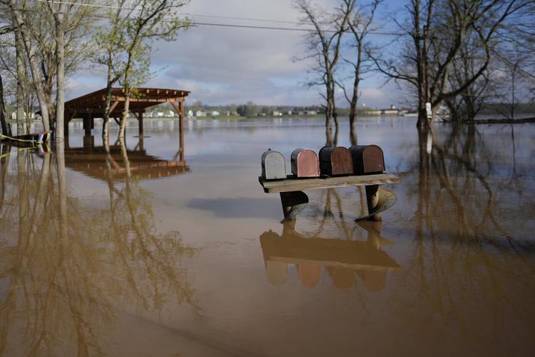Kentucky watches for surging rivers to recede so widespread cleanup can begin