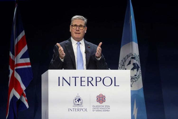 UK leader tells Interpol meeting world must 'wake up' to threat from people-smugglers