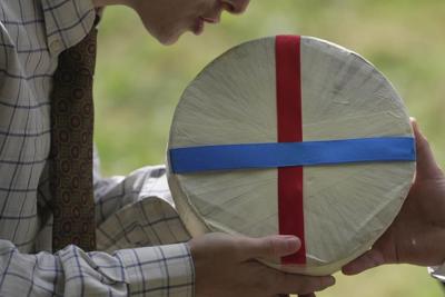 Rolling thunder: Contestants chase cheese wheel down a hill in chaotic UK race