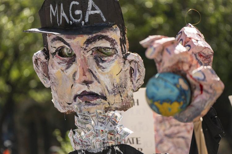 Photos show activists targeting billionaires in a street protest on the eve of New York Climate Week