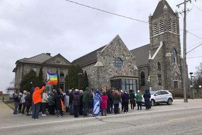 Catholic priest resigns from Michigan church following protests over his criticism of a gay author