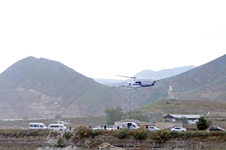 Official says rescuers see helicopter that was carrying Iran's president, others at a distance