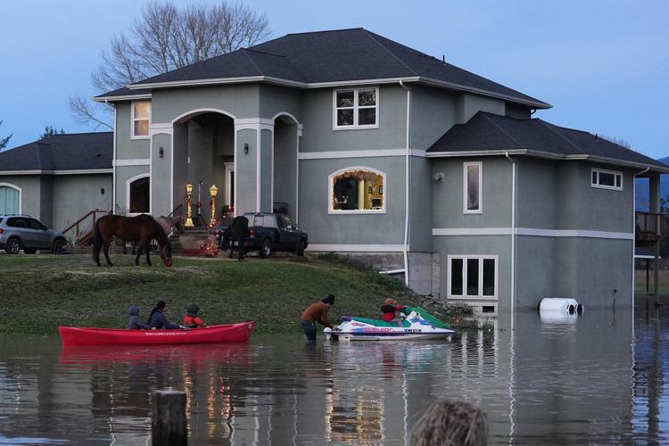Arctic air sweeps south as residents of the Pacific Northwest remain on guard after severe flooding