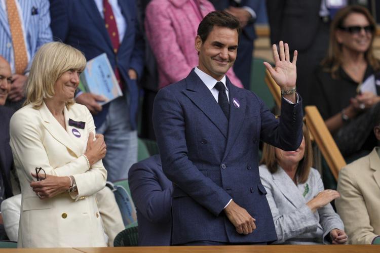 Roger Federer sits in Wimbledon's Royal Box to watch rival Novak Djokovic win
