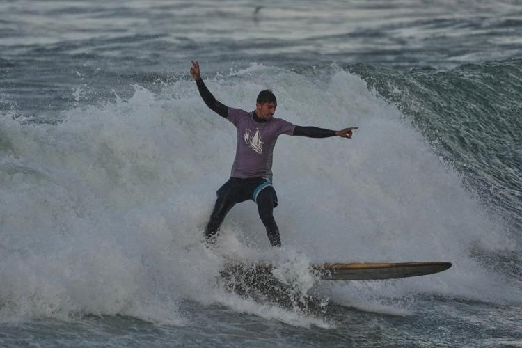 Photos show surfers riding waves along Gaza City’s damaged coastline