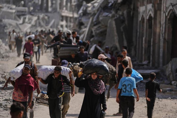 The Latest: Tens of thousands of Palestinians in Gaza return north as ceasefire takes effect