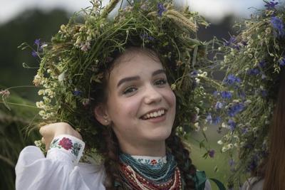 Under curfew, Ukrainians mark midsummer with bonfire jumping at a festival with pagan roots