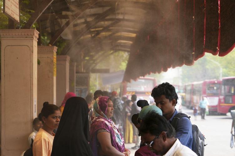 In one Indian city, reflective paint and bus stop sprinklers offer relief from killer heat