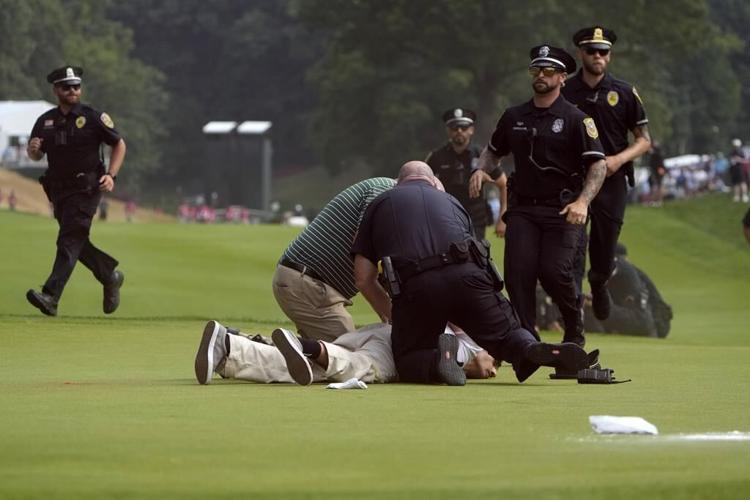 Six climate protesters run onto 18th green and spray powder, delaying finish of PGA Tour event