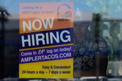US jobless aid filings fall to 215,000 last week as layoffs remain low despite economic headwinds