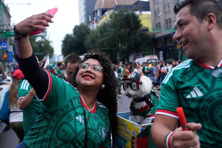 Rescue dog Osito steals hearts at the World Cup, one bike ride at a time