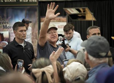 It's a pork chop on a stick and a vanilla shake for Tim Walz at the Minnesota State Fair