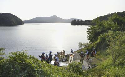 Japan retrieves remains of 1 of 2 service members whose training plane crashed