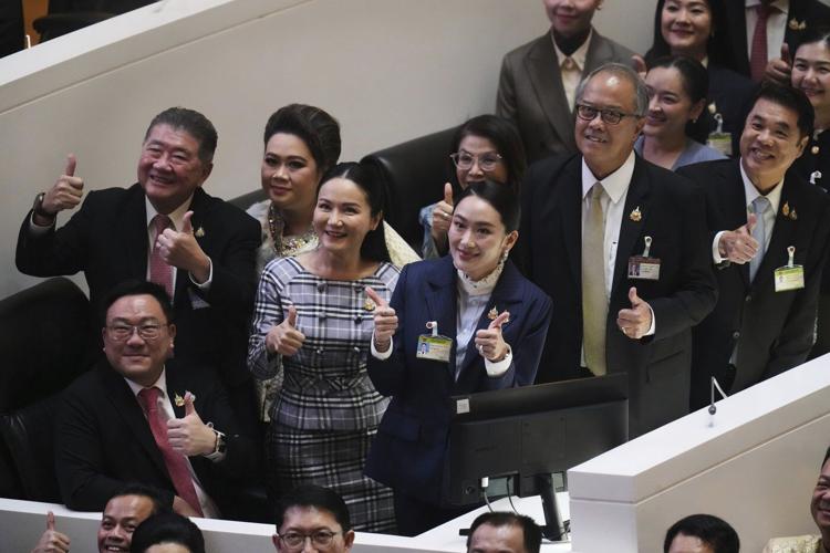 Thai prime minister survives a challenge by rivals who say her father is pulling the strings