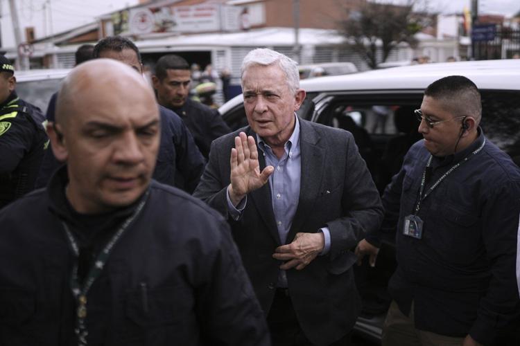 Colombian ex-leader known for contentious war on rebels pays tribute to slain presidential hopeful