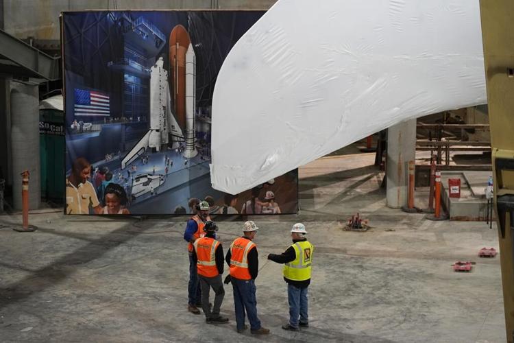 Space shuttle Endeavour hoisted for display in launch configuration at Los Angeles science museum