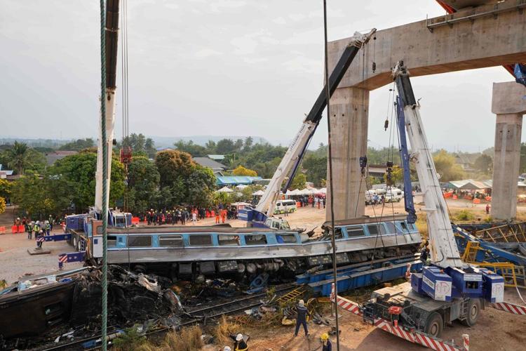 Photos show rescue workers at scene of crane collapse and train derailment in Thailand
