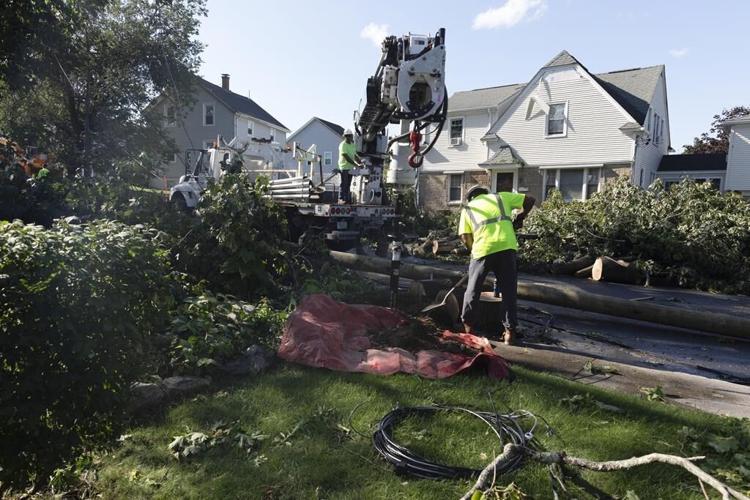 Rare New England tornado lifts car from a highway as strong storms damage homes and flood roads