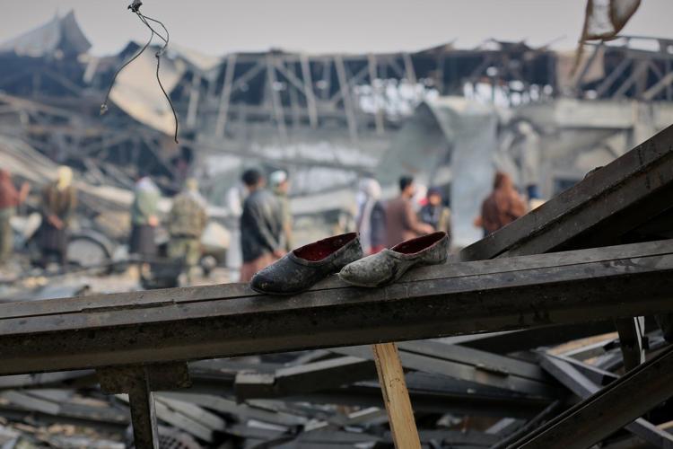 Rescue crews race through rubble after a deadly Kabul airstrike, in photos