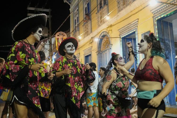 Families and revelers party side-by-side in a traditional Carnival in Sao Paulo's countryside