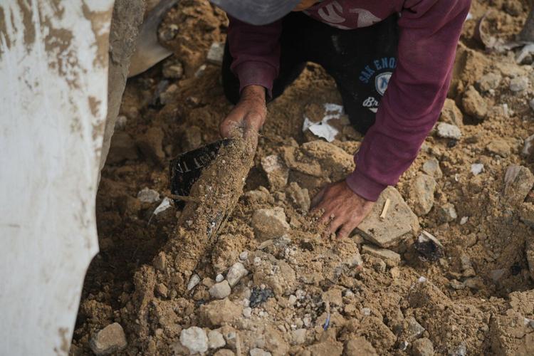 A father in Gaza searches for his family's bones in the rubble of their home