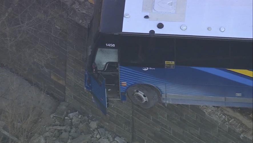 Front of NYC bus left hanging near a Bronx overpass after accident