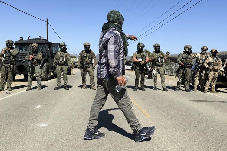 Photos of a confrontation between protesters and federal officials outside California farm