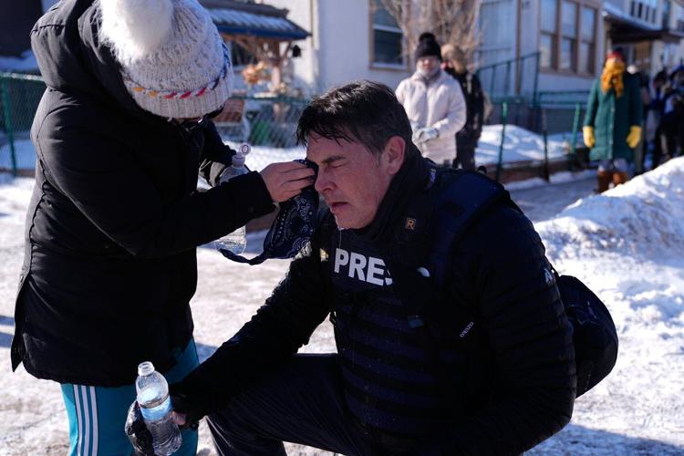 Officers react with crowd after man was killed in Minneapolis amid immigration crackdown, in photos