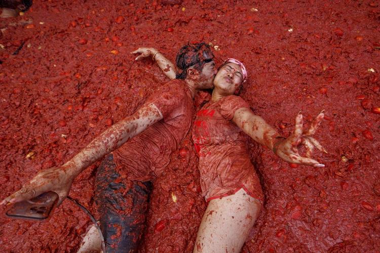 Photos show revelers taking part in Tomatina, the tomato-throwing festival in Spain