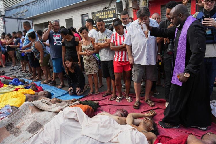 Brazilians in a Rio favela line up bodies after the city's deadliest police raid