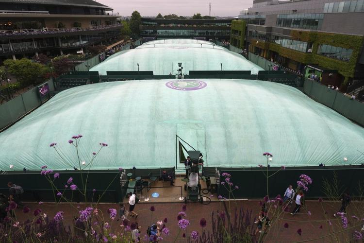 Photos show the rain on Day 3 after the Wimbledon heatwave