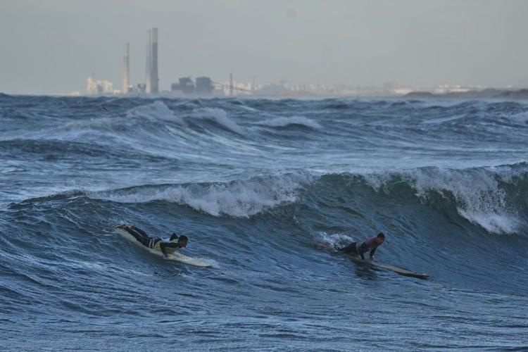 Photos show surfers riding waves along Gaza City’s damaged coastline
