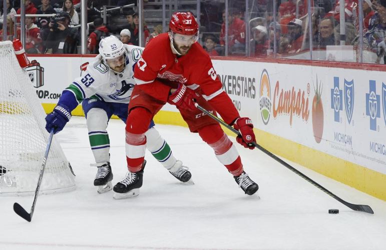 Jake DeBrusk scores hat trick, including OT game-winner, as Canucks top Red Wings 5-4