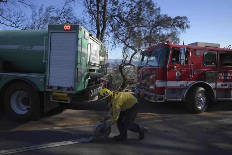 Southern California firefighters make progress against wildfire as fierce winds start to subside