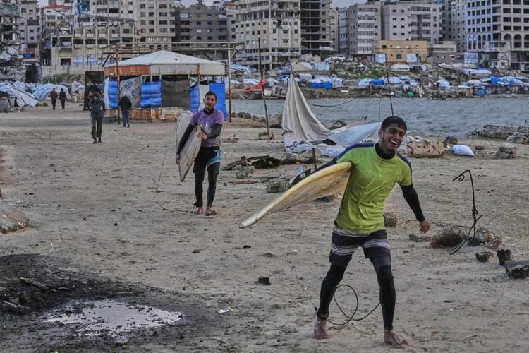 Photos show surfers riding waves along Gaza City’s damaged coastline