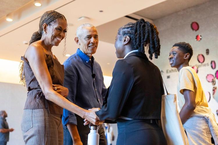 Barack and Michelle Obama surprise first visitors to newly opened presidential center