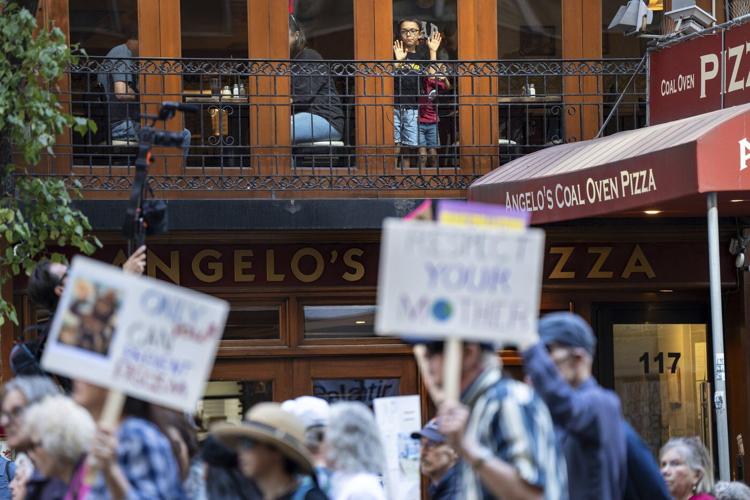 Photos show activists targeting billionaires in a street protest on the eve of New York Climate Week