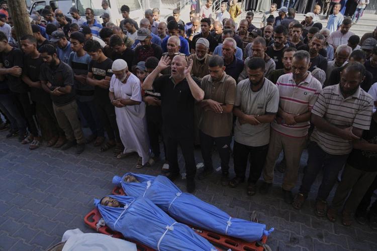 Photos show Palestinians mourning after people were killed in Israeli strikes