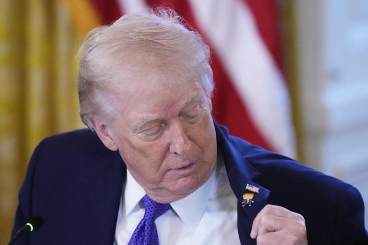 Trump wears a new 'Happy Trump' lapel pin, but insists he's never happy