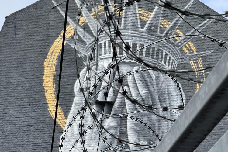 A new mural in France shows the Statue of Liberty covering her eyes in a swipe at Trump
