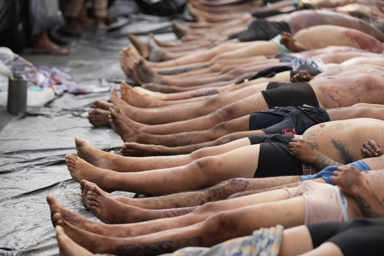 Brazilians in a Rio favela line up bodies after the city's deadliest police raid