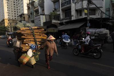 E-waste is overflowing landfills. At one sprawling Vietnam market, workers recycle some of it