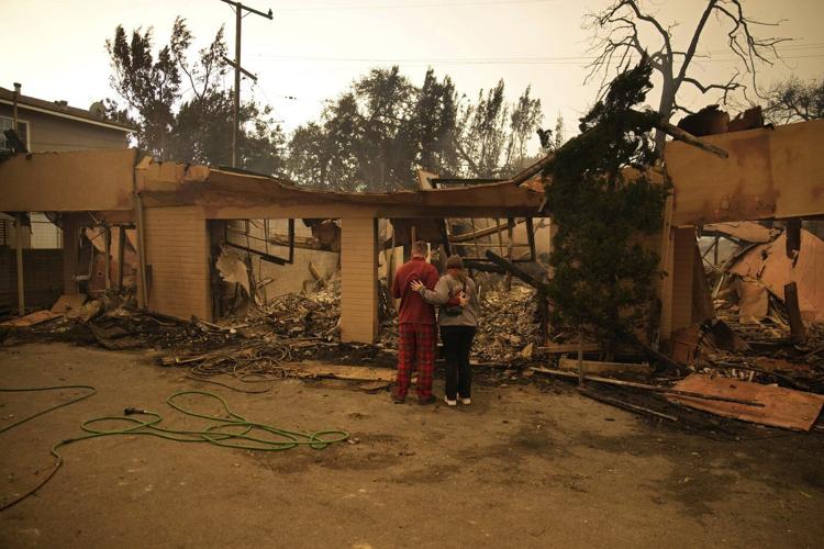 Fires devastating Los Angeles grow more slowly as fierce winds die down