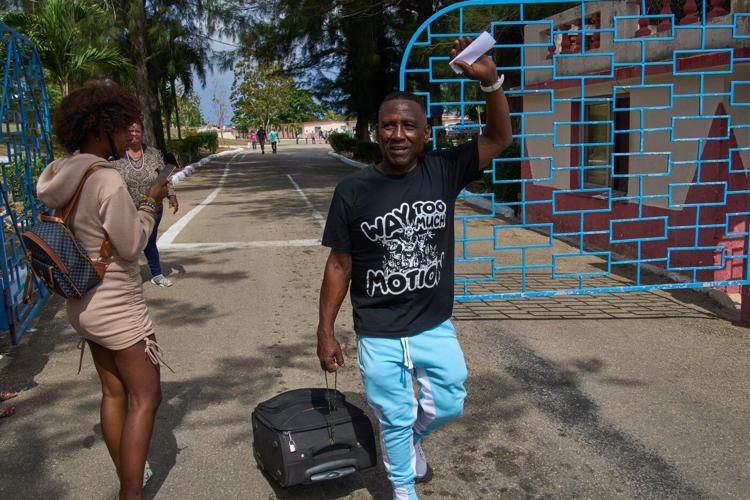 Photos of freed prisoners reuniting with families outside a Cuban prison
