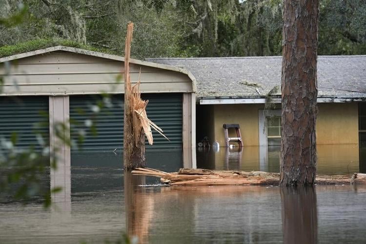Residents slog through flooded streets, clear debris after Hurricane Milton tore through Florida