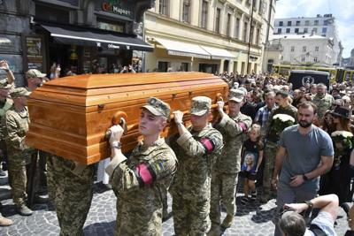 Thousands in Ukraine attend funeral of former lawmaker and critic of Russia who was killed in Lviv